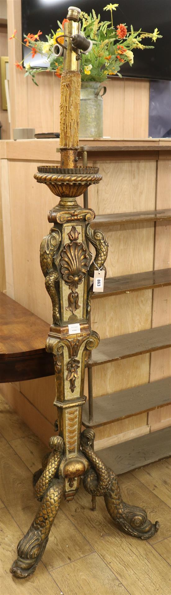A Florentine style carved cream and gilt painted standard lamp, on dolphin supports Width of base 59cm
